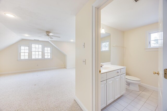 bathroom with plenty of natural light, a ceiling fan, toilet, and vanity