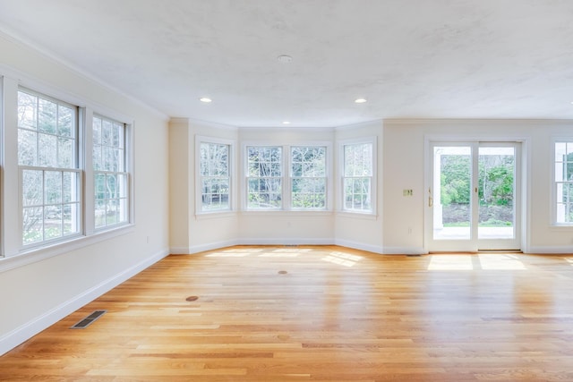 unfurnished living room with crown molding and baseboards