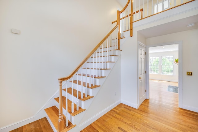 stairs featuring baseboards and wood finished floors