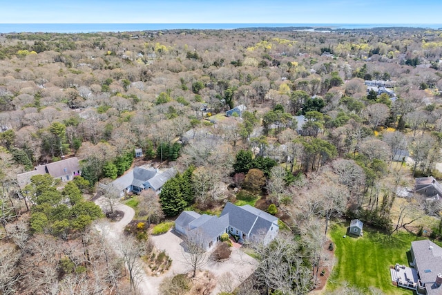 birds eye view of property with a view of trees