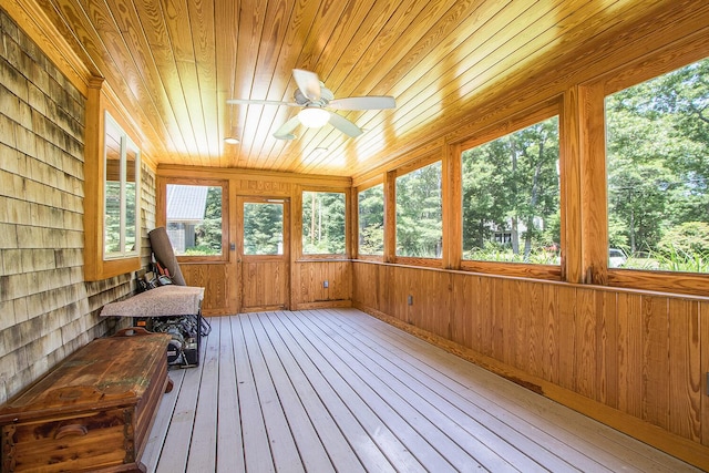 unfurnished sunroom featuring ceiling fan and wooden ceiling