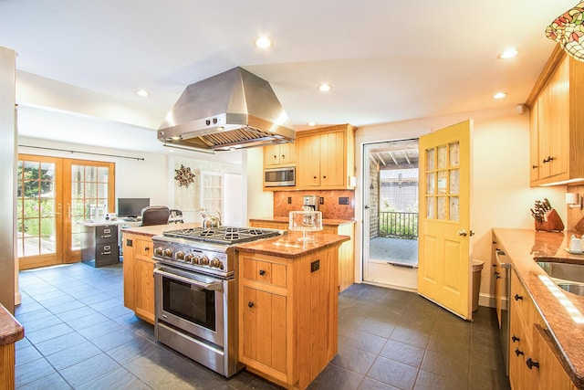 kitchen with light brown cabinets, french doors, a kitchen island, island range hood, and stainless steel appliances