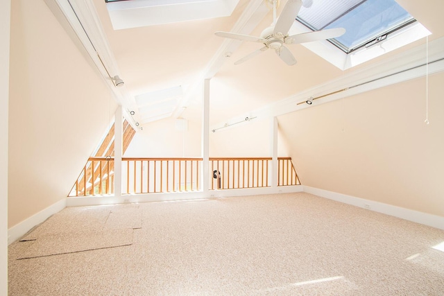 additional living space with ceiling fan, carpet, and lofted ceiling with skylight