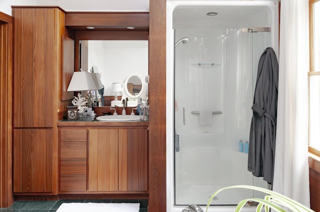 bathroom with vanity, a shower with shower door, and tile patterned floors