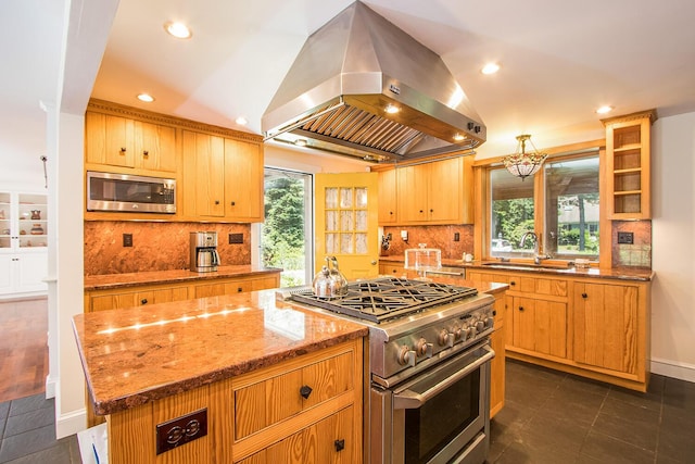 kitchen with appliances with stainless steel finishes, a center island, lofted ceiling, island exhaust hood, and sink