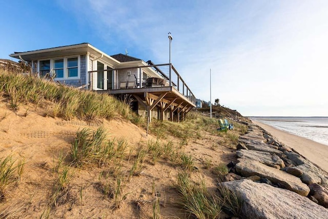 exterior space with a beach view and a water view