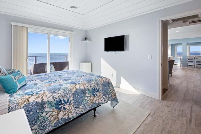 bedroom featuring access to exterior, crown molding, visible vents, wood finished floors, and baseboards