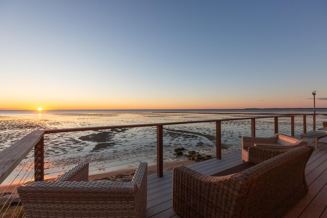 balcony featuring a beach view and a water view