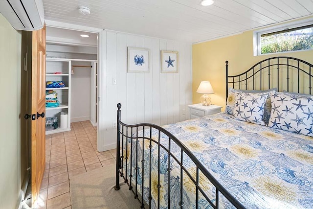 bedroom with recessed lighting, a wall unit AC, a spacious closet, and light tile patterned floors