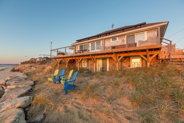 rear view of house featuring a deck