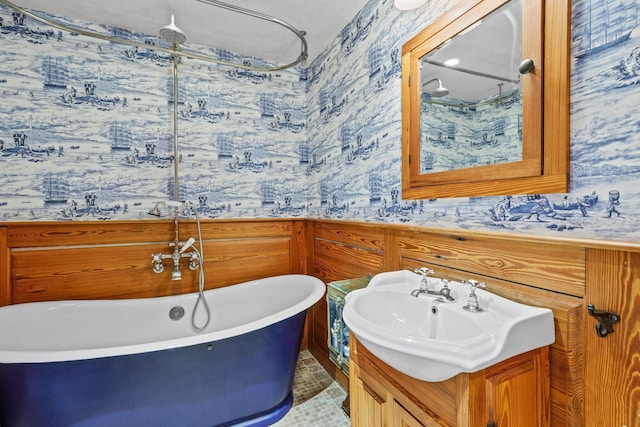260 Bradford St, Provincetown, MA 02657 - bathroom featuring wallpapered walls, a soaking tub, and vanity