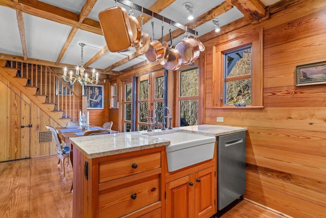 260 Bradford St, Provincetown, MA 02657 - kitchen with wooden walls, stainless steel dishwasher, a sink, a chandelier, and light wood-type flooring