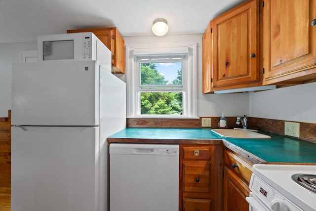 1079 State Hwy Unit 14, Eastham, MA 02642 - kitchen featuring white appliances and brown cabinetry