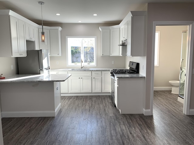 72 Grove St, Hyannis, MA 02601 - kitchen featuring appliances with stainless steel finishes, dark wood-style flooring, light stone counters, white cabinetry, and recessed lighting