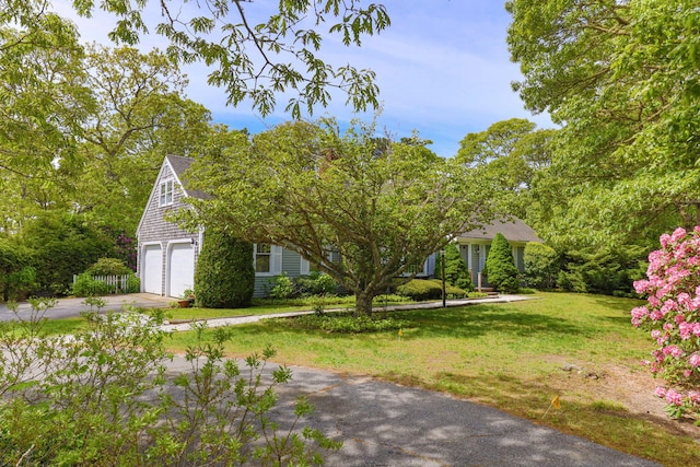 100 Potonumecot Rd, Chatham, MA 02633 - view of front of house with driveway, a front lawn, and a garage