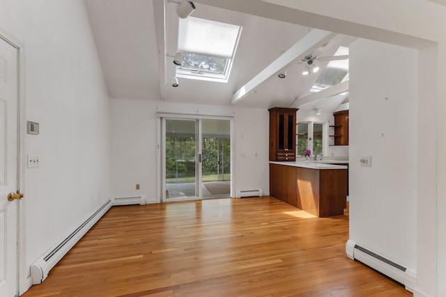 100 Potonumecot Rd, Chatham, MA 02633 - unfurnished living room with a skylight, a baseboard heating unit, a baseboard radiator, vaulted ceiling, and light wood finished floors