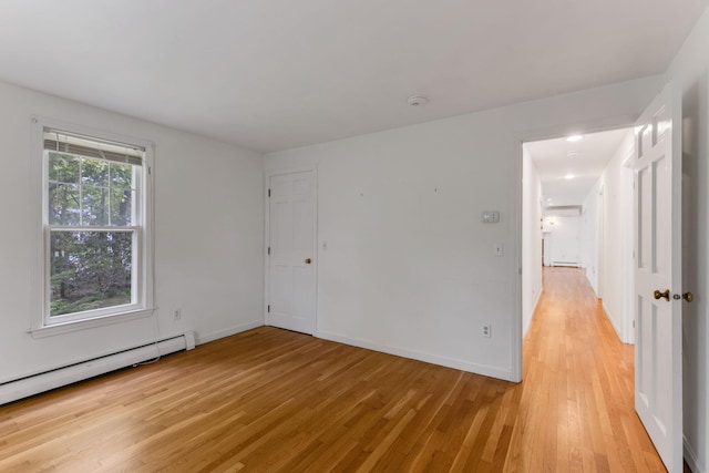 100 Potonumecot Rd, Chatham, MA 02633 - unfurnished room with a baseboard heating unit, light wood-style flooring, and baseboards