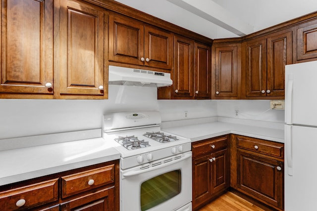 100 Potonumecot Rd, Chatham, MA 02633 - kitchen featuring white appliances, under cabinet range hood, light countertops, and light wood-style flooring