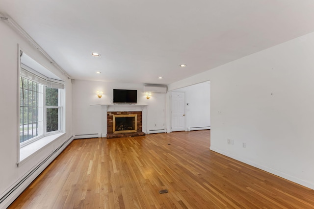 100 Potonumecot Rd, Chatham, MA 02633 - unfurnished living room featuring a baseboard radiator, a wall mounted AC, a brick fireplace, light wood-style flooring, and recessed lighting