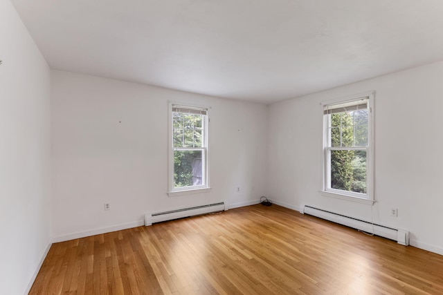 100 Potonumecot Rd, Chatham, MA 02633 - empty room with a baseboard heating unit, a baseboard radiator, light wood-style flooring, and baseboards