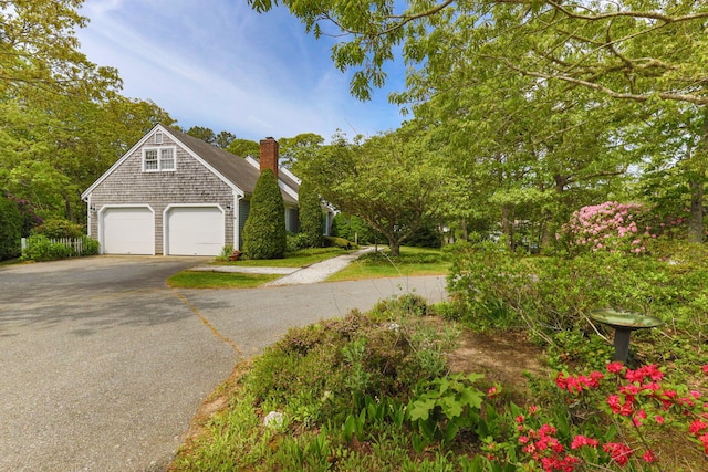 100 Potonumecot Rd, Chatham, MA 02633 - view of front of house featuring asphalt driveway and a chimney