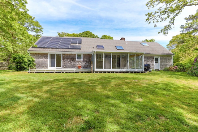 100 Potonumecot Rd, Chatham, MA 02633 - rear view of house featuring solar panels, a yard, a sunroom, and a chimney