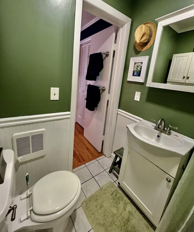 3 Winthrop St Unit U1, Provincetown, MA 02657 - bathroom featuring vanity, a wainscoted wall, toilet, and tile patterned floors