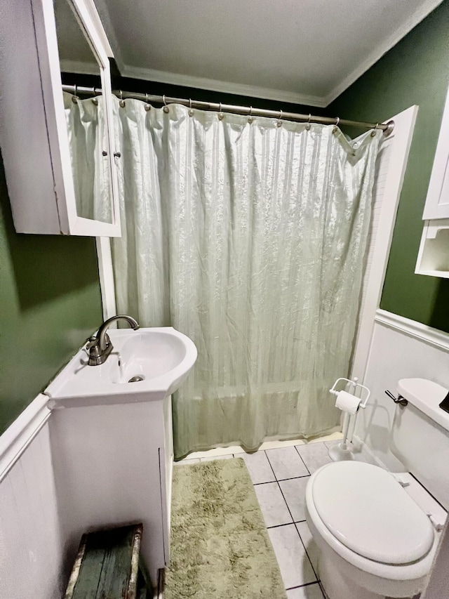 3 Winthrop St Unit U1, Provincetown, MA 02657 - full bathroom with ornamental molding, toilet, vanity, a wainscoted wall, and a decorative wall