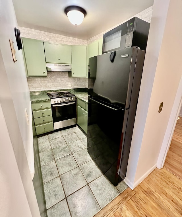 3 Winthrop St Unit U1, Provincetown, MA 02657 - kitchen with green cabinetry, stainless steel electric range, freestanding refrigerator, under cabinet range hood, and tasteful backsplash