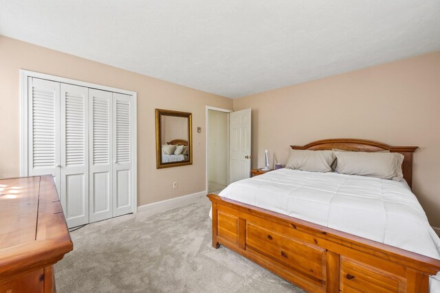 154 Cotuit Bay Dr, Cotuit, MA 02635 - bedroom featuring light carpet, a closet, and baseboards