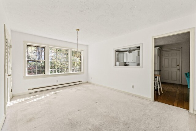 154 Cotuit Bay Dr, Cotuit, MA 02635 - empty room featuring baseboard heating, carpet flooring, baseboards, and a textured ceiling