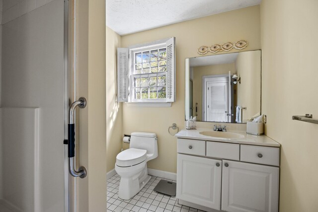 154 Cotuit Bay Dr, Cotuit, MA 02635 - full bathroom with vanity, toilet, tile patterned floors, baseboards, and a shower with door