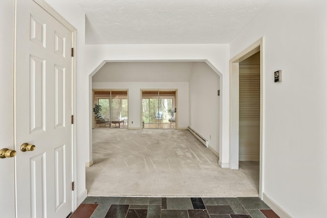 154 Cotuit Bay Dr, Cotuit, MA 02635 - hallway featuring a baseboard radiator, dark carpet, baseboards, and dark stone finish flooring