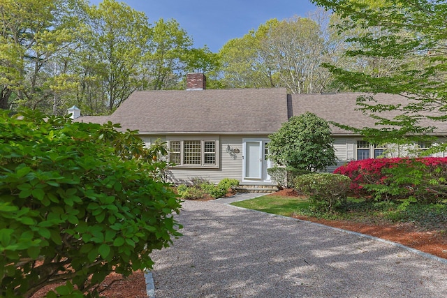 154 Cotuit Bay Dr, Cotuit, MA 02635 - view of front of home with a chimney, entry steps, and a shingled roof