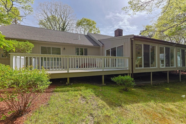 154 Cotuit Bay Dr, Cotuit, MA 02635 - rear view of property featuring a chimney, a wooden deck, a yard, a sunroom, and a shingled roof