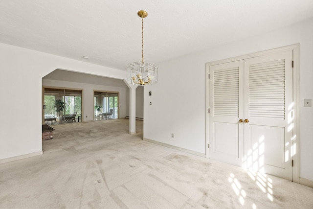 154 Cotuit Bay Dr, Cotuit, MA 02635 - unfurnished dining area featuring a chandelier, carpet, and baseboards