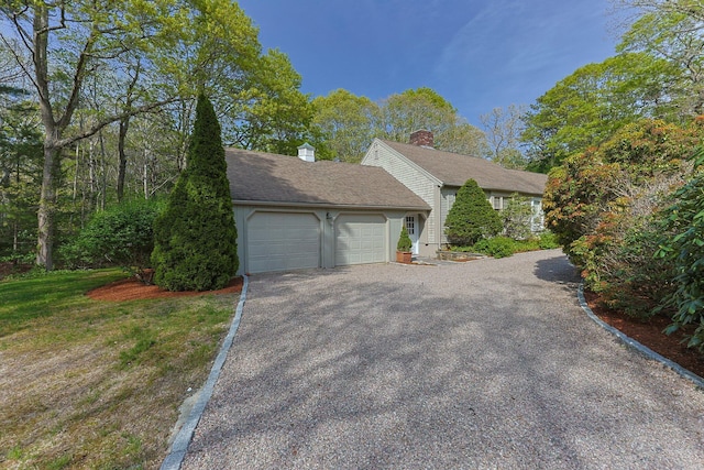 154 Cotuit Bay Dr, Cotuit, MA 02635 - view of home's exterior featuring an attached garage, driveway, and a chimney