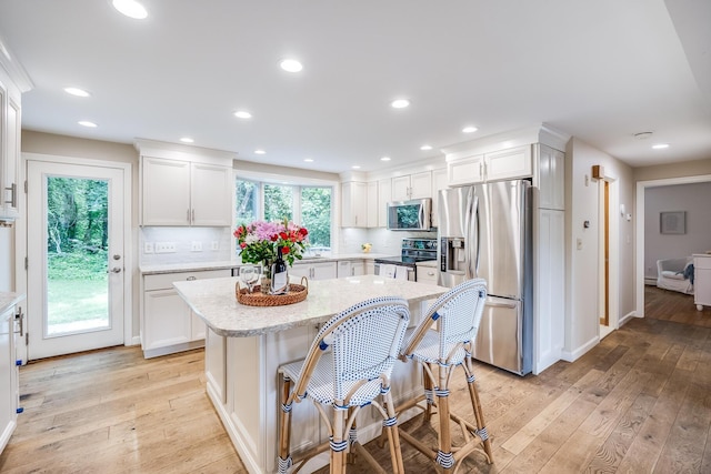 7 Liberty Pl, East Dennis, MA 02641 - kitchen featuring stainless steel appliances, light wood-style floors, white cabinetry, and recessed lighting