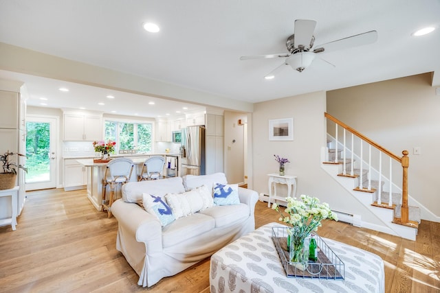 7 Liberty Pl, East Dennis, MA 02641 - living room with baseboard heating, ceiling fan, recessed lighting, stairway, and light wood-style flooring