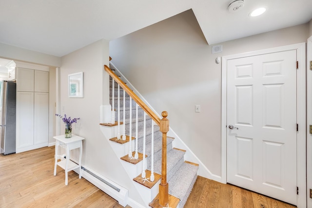 7 Liberty Pl, East Dennis, MA 02641 - stairs featuring baseboard heating, wood finished floors, and baseboards