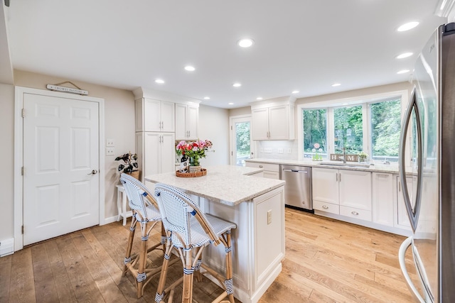 7 Liberty Pl, East Dennis, MA 02641 - kitchen featuring appliances with stainless steel finishes, a sink, a center island, white cabinets, and recessed lighting