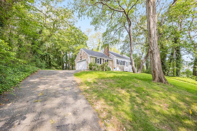 7 Liberty Pl, East Dennis, MA 02641 - view of front of home featuring a chimney, driveway, and a front yard