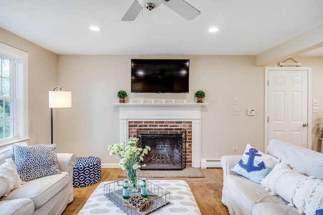 7 Liberty Pl, East Dennis, MA 02641 - living area with a baseboard radiator, a fireplace, wood finished floors, recessed lighting, and a ceiling fan