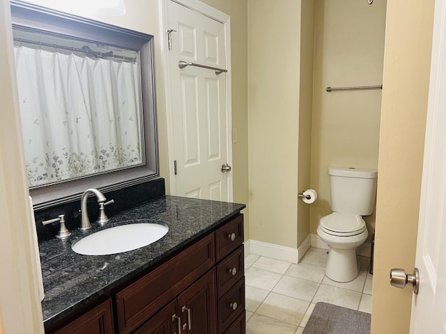 bathroom featuring toilet, tile patterned flooring, and vanity