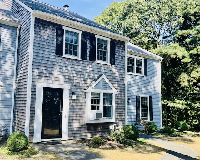 colonial house featuring cooling unit