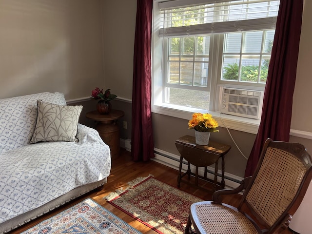 bedroom with a baseboard radiator, dark wood-type flooring, and cooling unit