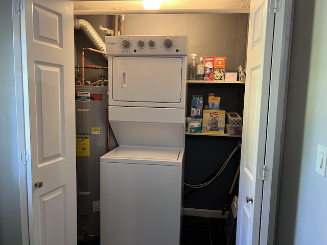 laundry room with stacked washer / drying machine and water heater