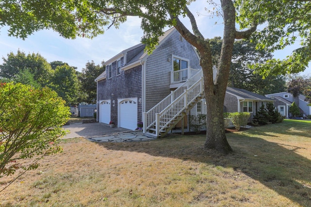 97 Great Western Rd, Harwich, MA 02645 - back of house featuring a yard, stairway, driveway, and a garage