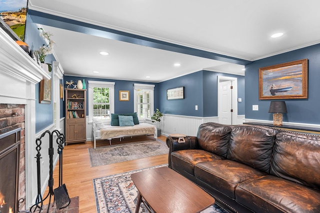 13 Old Fields Rd, Sandwich, MA 02563 - living room featuring crown molding, light wood finished floors, a wainscoted wall, recessed lighting, and a lit fireplace