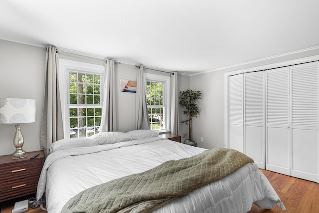 13 Old Fields Rd, Sandwich, MA 02563 - bedroom with wood finished floors, multiple windows, a closet, and ornamental molding
